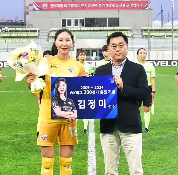 사진제공=현대제철 / 지난 22일 인천남동럭비경기장에서 김정미 선수의 WK리그 300경기 출전 기념 행사가 열렸다. 서상원 현대제철 레드엔젤스 단장이 기념패를 전달하고, 김정미 선수와 기념 촬영을 하고 있다.