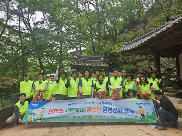 사진제공=농협 / 농림수산업자신용보증기금 상무 조은주(왼쪽에서 7번째, 가운데 안경착용 여성)외 농신보 동행봉사단이 환경정화 활동 기념 촬영을 하고 있다.