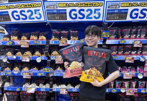 고객이 일본 돈키호테에 입점한 GS25의 넷플릭스 점보 팝콘을 들고 환하게 웃고 있다. / 사진=GS리테일