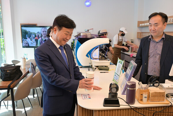 정기명 여수시장이 관내 사회적경제기업 ‘모어레스커피’에서 탄소중립 실천포인트 앱 ‘반들이’ 이용법을 시연하고 있다. / 사진=여수시