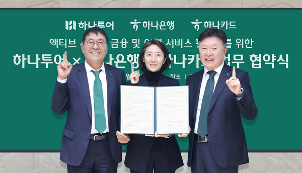 협약식에 참석한 김진우 하나은행 중앙영업그룹장(왼쪽), 이완근 하나카드 영업그룹장(오른쪽), 송미선 하나투어 대표이사(가운데)가 함께 기념촬영을 하고 있다. 사진=하나은행